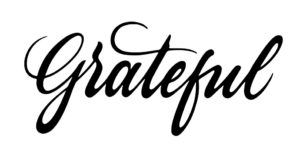 white background with black cursive font on top that reads 'Grateful'